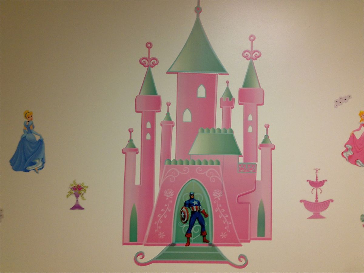 A Captain Marvel wall decor sticker thrown on top of a Princess Castle wall decor sticker